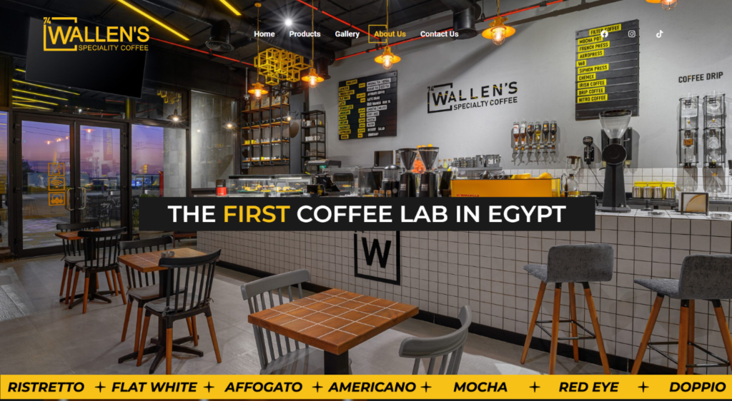 The image shows the interior of the first coffee lab in Egypt, featuring modern equipment and a cozy seating area.
